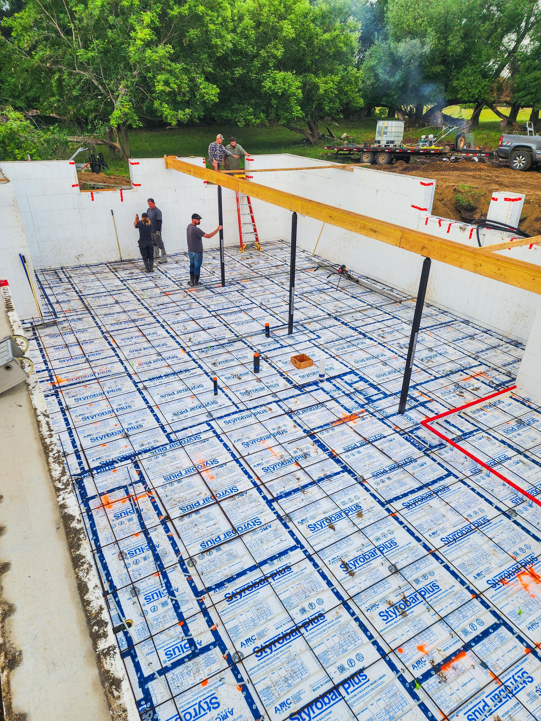 Under-slab insulation and reinforcement prepared for a basement floor