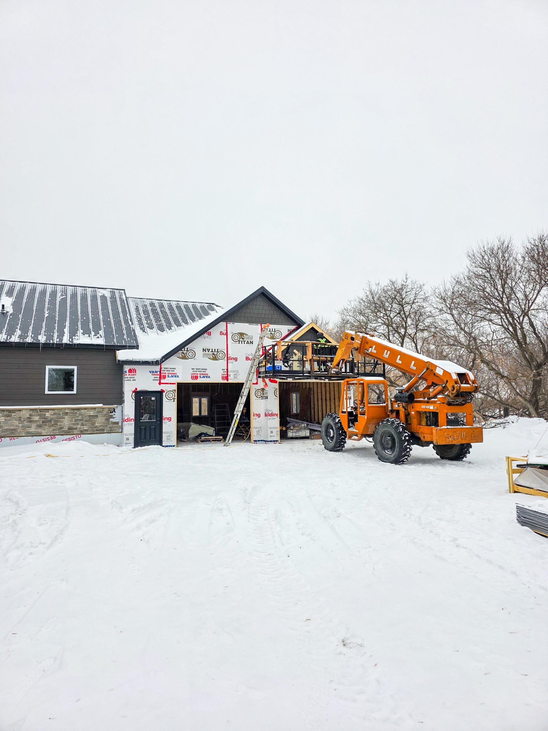 Exterior siding being installed on a garage addition